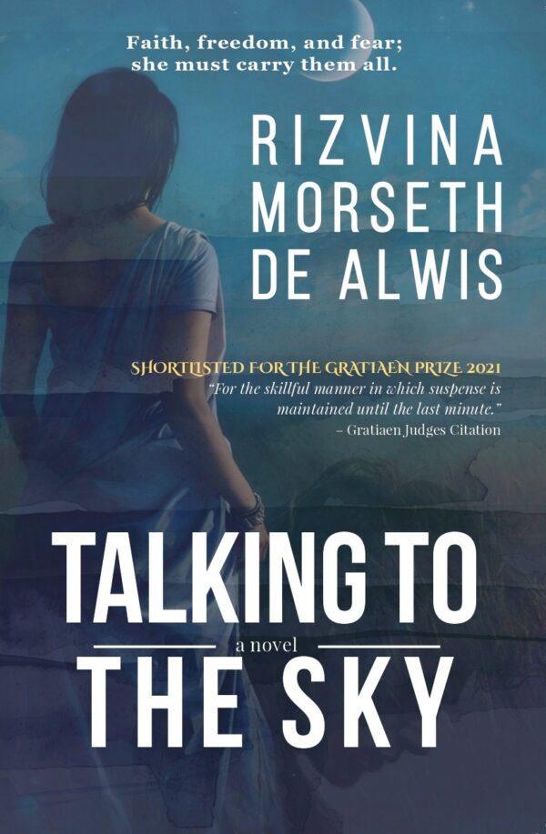 A woman in a sari looking into the horizon in a dark blue background. On the bottom right corner is a profile of a young man looking down. Title of book 'Talking to the Sky' in all caps at the bottom centre of the cover.